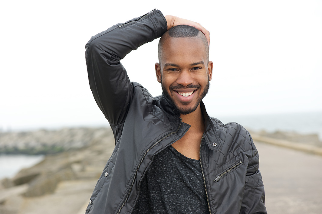 smiling-man-poses-on-coastal-path-in-jacket-2026-01-05-05-39-02-utc